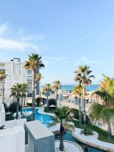a view of a resort with palm trees and a pool at Breathtaking Apartment in Torrevieja