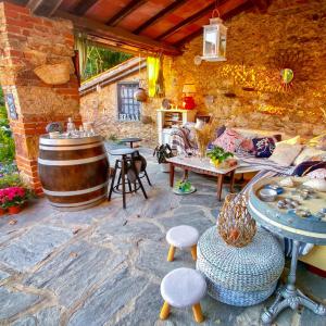 a room with a table, chairs, and a fire place at B&B Antico Frantoio Pietrasanta in Pietrasanta
