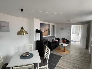 a living room with a table and a dining room at Ferienapartment Stemmert in Gelting