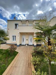 a building with a wooden walkway in front of it at Residence Alassa in Montévrain