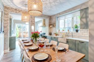 a dining room with a long table and chairs at The Beach House - Cromer in Cromer