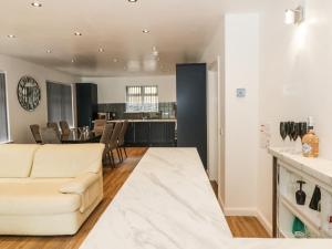 a living room with a white couch and a table at Heatherbank in Garelochhead