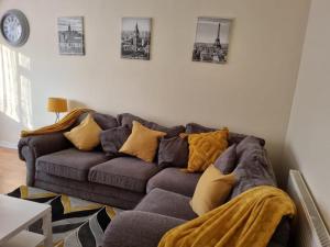 a living room with a couch and pictures on the wall at Captivating 2-Bed Apartment in Belvedere in Belvedere