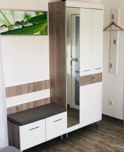 a dressing room with a bench and a mirror at Apartment Oase- Kaiserslautern in Kaiserslautern