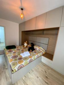 a bedroom with a bed with a stuffed animal on it at Elegant Apartment in City Centre in Prishtinë