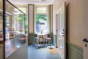 a kitchen with a table and chairs and a window at Stadshotel Steegoversloot in Dordrecht