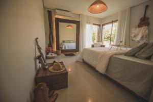 a bedroom with a bed and a large mirror at Kaza Mazamore - Entire luxurious Vila in Itaunas. in Conceição da Barra