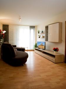 a living room with a couch and a tv at Ferienwohnung Fernblick in Saarbrücken