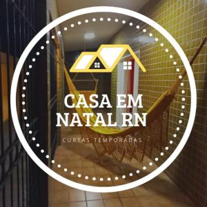 a sign that says casa em natalr in a store window at Casa para Temporada Natal in Natal