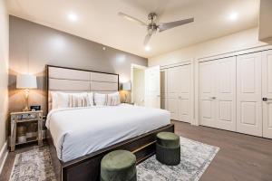 a bedroom with a large bed and white cabinets at The Esplanade in New Orleans