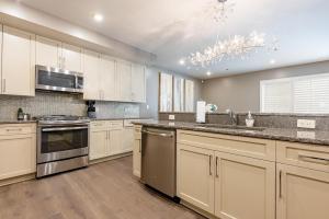 a kitchen with white cabinets and stainless steel appliances at The Esplanade in New Orleans