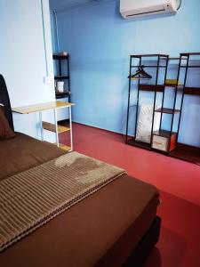 a bedroom with a bed and a blue wall at Permata Beach Chalet in Kampong Juara +37 photos