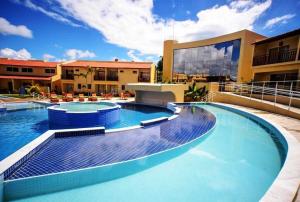 a swimming pool on the side of a building at Solar Agua Flats Elegance Flat in Pipa