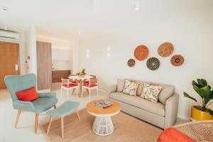 a living room with a couch and a table at Domaine de Grand Baie in Grand-Baie