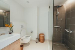 a bathroom with a toilet and a shower at Domaine de Grand Baie in Grand-Baie