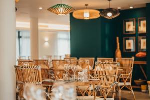a dining room with wooden tables and chairs at Domaine de Grand Baie in Grand-Baie
