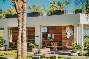 a resort with a palm tree in front of a building at Domaine de Grand Baie in Grand-Baie