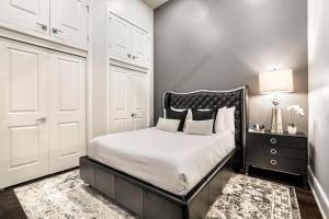 a bedroom with a black and white bed and a lamp at The Steamboat in New Orleans