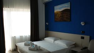Postel nebo postele na pokoji v ubytování Hotel Palazzo Caveja