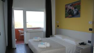 Postel nebo postele na pokoji v ubytování Hotel Palazzo Caveja
