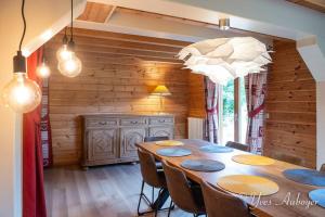 a dining room with a table and chairs at Chalet La Revoyotte in Le Ménil