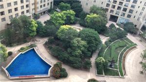 an overhead view of a park with a swimming pool and trees at Tianjin Crown International Apartment in Tianjin