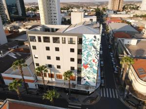 an aerial view of a building with a mural on it at LA HOTEL VOTUPORANGA in Votuporanga
