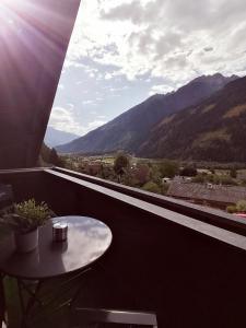 a table on a balcony with a view of mountains at Apartments Zwigl in Flattach