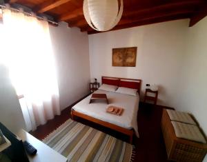 a bedroom with a bed and a large window at In Corte al Laghetto in Merate