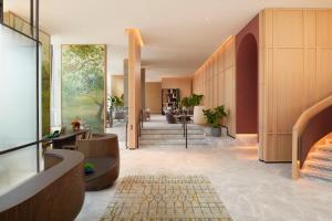 a lobby of a building with a staircase at Pan Pacific London in London