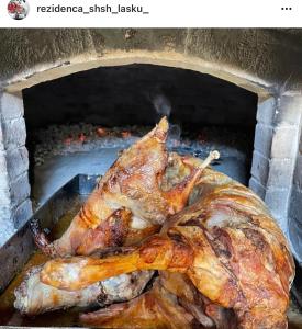 a turkey being cooked in a brick oven at Hotel SH & SH in Pukë