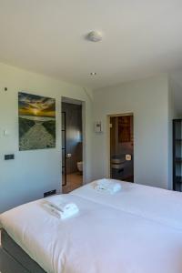 Ένα ή περισσότερα κρεβάτια σε δωμάτιο στο Vakantiewoning De Bleekersvallei