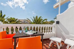 a balcony with a table and chairs and palm trees at Boutique Hotel Pueblo in Benalmádena