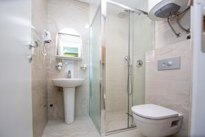 a bathroom with a shower and a toilet and a sink at Apartment Sofija in Budva