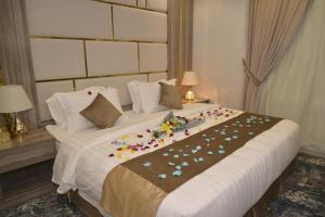 a bedroom with a large bed with flowers on it at Lavana Sari in Jeddah