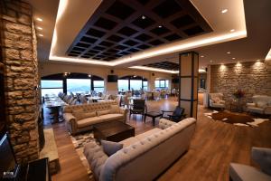 
a living room filled with furniture and a large window at Nevros Hotel Resort and Spa in Neochori
