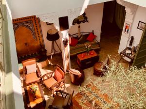 an overhead view of a living room with chairs and a couch at Dar Zemrane in Marrakesh