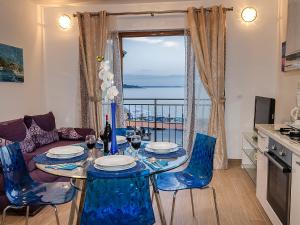 a living room with a table and chairs with a view at Sanja Apartments Rivarela in Novigrad Istria