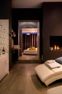 a bedroom with a bed with a fireplace and a mirror at The Rose Suites in Bruges