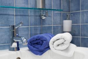 a bathroom sink with towels and a faucet at Apartment Omega in Creglingen