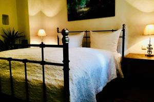 a bedroom with a black bed with white sheets and pillows at Apartment Omega in Creglingen