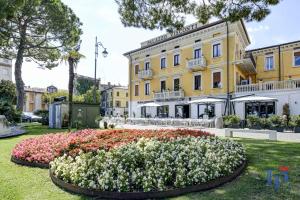 a flower bed in front of a building at Palazzo Visconti Luxury Suite DesenzanoLoft Official Partner Homes & Villas by Marriott Bonvoy in Desenzano del Garda