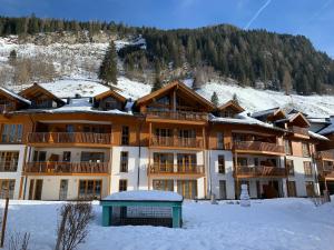 a large apartment building with snow on the ground at Schoenblick Mountain Resort - by SMR Rauris Apartments - Includes National Sommercard & Spa - close to Gondola in Rauris