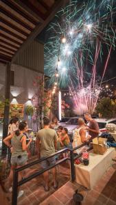 a group of people sitting at a table watching fireworks at Summer Delight B&B in Nanwan