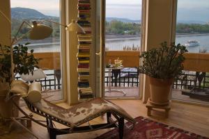 a room with a chair and a window with a view at High End Budapest in the city center in Budapest