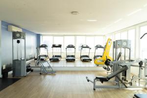a gym with a row of treadmills and machines at Plaza São Rafael Hotel in Porto Alegre