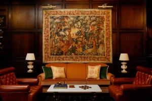 a large tapestry hanging on a wall above a couch at Rusacks St Andrews in St. Andrews