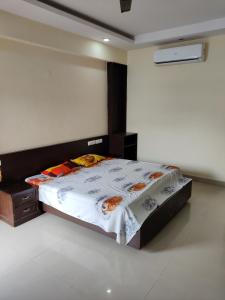 a bedroom with a large bed in a room at Fernandes Complex in Bangalore