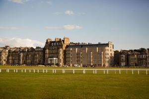 a large building with a grass field in front of it at Rusacks St Andrews in St. Andrews