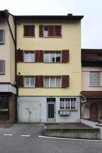 a large yellow building with a lot of windows at Bright and modern apartment in the heart of Altstätten in Altstätten
